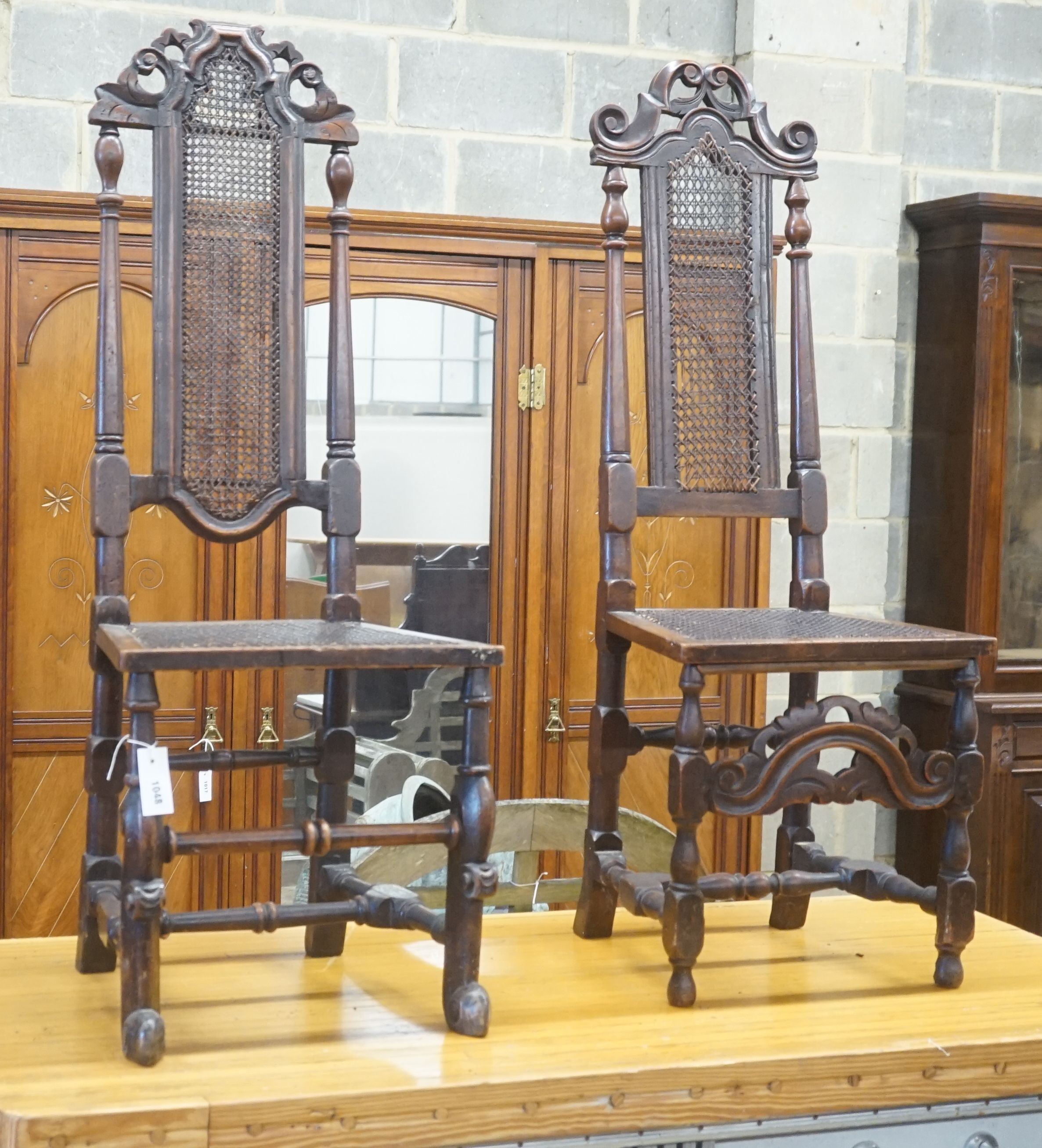 An associated pair of Carolean style high back dining chairs